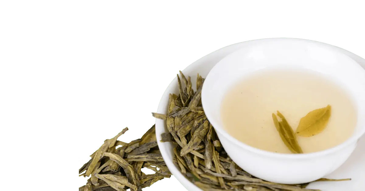 a white cup and saucer filled with longjing tea and a few loose leaves